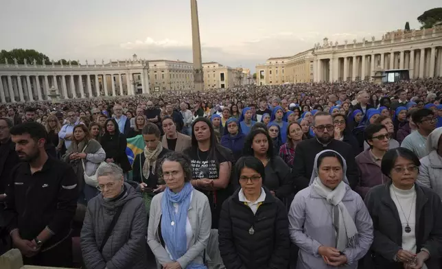 Faithful participate in a rosary prayer for the late Pope Francis, in St. Peter's Square at the Vatican, Monday April 21, 2025. (AP Photo/Alessandra Tarantino)
