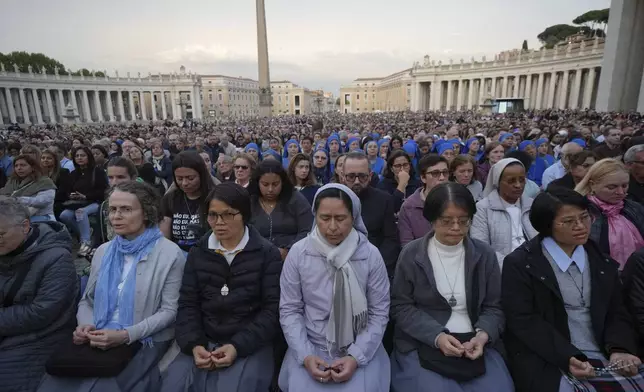 Faithful participate in a rosary prayer for the late Pope Francis, in St. Peter's Square at the Vatican, Monday April 21, 2025. (AP Photo/Alessandra Tarantino)