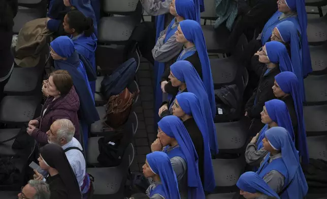 Nuns and faithful attend a rosary prayer for the late Pope Francis, in St. Peter's Square at the Vatican, Monday April 21, 2025. (AP Photo/Andrew Medichini)