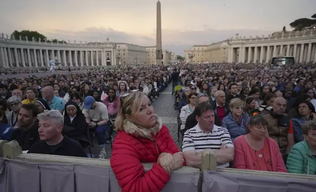 Faithful participate in a rosary prayer for the late Pope Francis, in St. Peter's Square at the Vatican, Monday April 21, 2025. (AP Photo/Alessandra Tarantino)