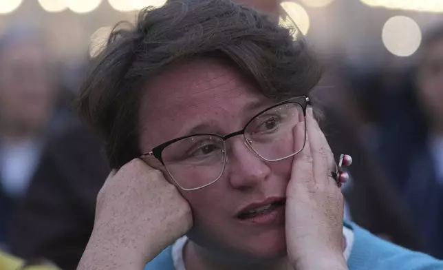 A woman attends a rosary prayer for the late Pope Francis, in St. Peter's Square at the Vatican, Monday April 21, 2025. (AP Photo/Alessandra Tarantino)