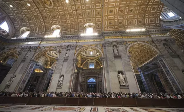 Faithful line up to pay their respects to Pope Francis inside St. Peter's Basilica at the Vatican, Wednesday, April 23, 2025, where his body will lie in state for three days. (AP Photo/Alessandra Tarantino)