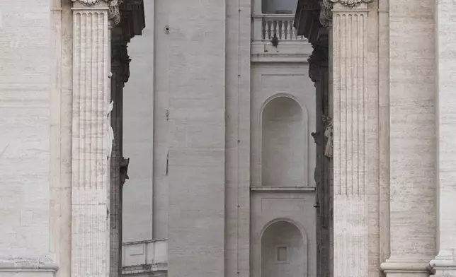 Vatican Swiss Guards stand at the Arch of the Bells where the body of Pope Francis will be carried on its way to St. Peter's Basilica, where it will lie in state for three days, at the Vatican, Wednesday, April 23, 2025. (AP Photo/Andrew Medichini)