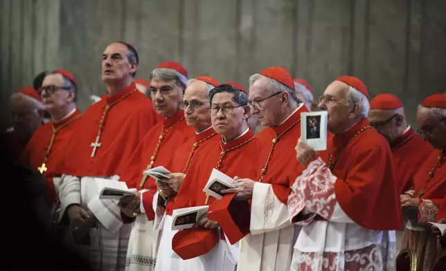 Cardinal Luis Antonio Taigle, center, attends the procession of the body of Pope Francis at St. Peter's Basilica at the Vatican, Wednesday, April 23, 2025, where he will lie in state for three days. (AP Photo/Alessandra Tarantino)