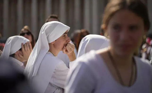 Nuns wait in St. Peter's Square to pay their respect to the late Pope Francis, who will lie in state at St. Peter's Basilica for three days, at the Vatican, Wednesday, April 23, 2025. (AP Photo/Andreea Alexandru)
