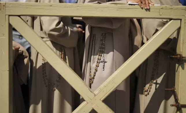 Nuns arriving from Spain, some from South America, wait in line to see the body of Pope Francis, who will lie in state for three days, in St. Peter's Basilica at the Vatican, Wednesday, April 23, 2025. (AP Photo/Francisco Seco)