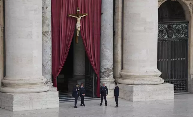 Security persons stand at St. Peter's Square ahead of the arrival of the body of Pope Francis, who will lie in state at St. Peter's Basilica for three days, at the Vatican, Wednesday, April 23, 2025. (AP Photo/Gregorio Borgia)