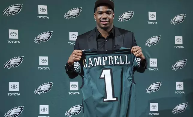 Alabama linebacker Jihaad Campbell, the Philadelphia Eagles' first round draft pick, selected 31st overall, poses with a jersey during an NFL football news conference at the team's training facility in Philadelphia, Friday, April 25, 2025. (AP Photo/Matt Rourke)