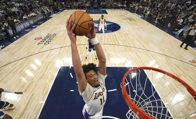 Los Angeles Lakers center Jaxson Hayes (11) goes up for a dunk during the first half of Game 4 of an NBA basketball first-round playoff series against the Minnesota Timberwolves, Sunday, April 27, 2025, in Minneapolis. (AP Photo/Abbie Parr)