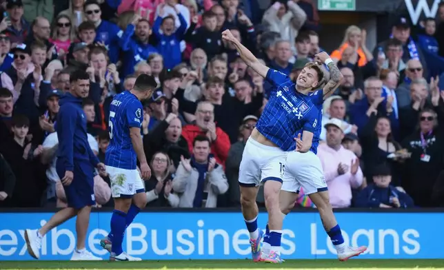 Ipswich Town's Liam Delap celebrates scoring his side's first goal of the game, during the English Premier League soccer match between Ipswich Town and Wolverhampton Wanderers, at Portman Road, in Ipswich, England, Saturday, April 5, 2025. (Bradley Collyer/PA via AP)