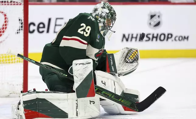 Minnesota Wild goaltender Marc-Andre Fleury makes a save against the Anaheim Ducks during overtime of an NHL hockey game Tuesday, April 15, 2025, in St. Paul, Minn. (AP Photo/Matt Krohn)