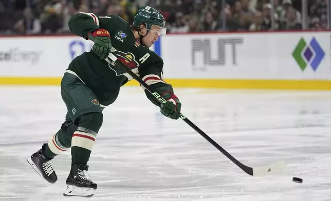 Minnesota Wild left wing Kirill Kaprizov (97) shoots the puck during the third period of an NHL hockey game against the San Jose Sharks, Wednesday, April 9, 2025, in St. Paul, Minn. (AP Photo/Abbie Parr)