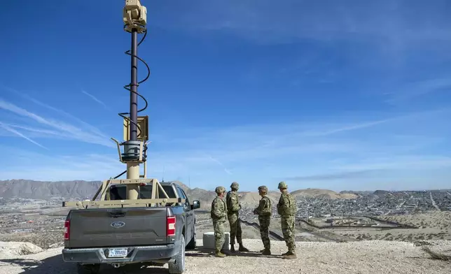 FILE - Army soldiers look at the border wall next to a surveillance vehicle during the visit to the U.S. and Mexico border by Defense Secretary Pete Hegseth in Sunland Park, N.M., Monday, Feb. 3, 2025. (AP Photo/Andres Leighton, File)