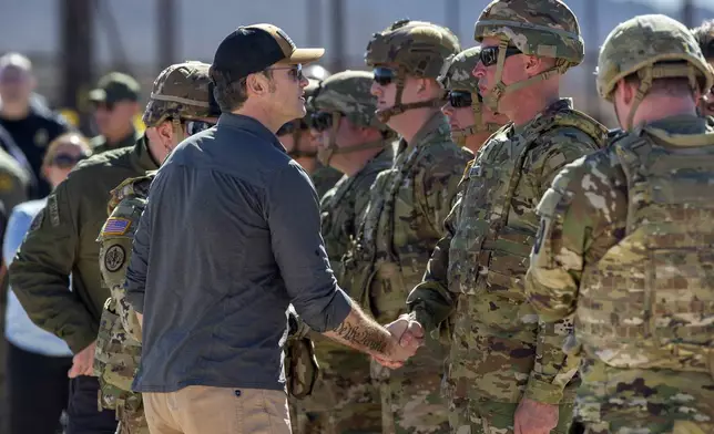 FILE - Defense Secretary Pete Hegseth, left, shakes hands with an Army soldier while visiting the US-Mexico border in Sunland Park,, N.M., Monday, Feb. 3, 2025. (AP Photo/Andres Leighton, File)