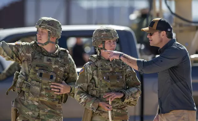 FILE - Defense Secretary Pete Hegseth, right, speaks as he's briefed by Army soldiers while visiting the US-Mexico border in Sunland Park, N.M., Monday, Feb. 3, 2025. (AP Photo/Andres Leighton, File)