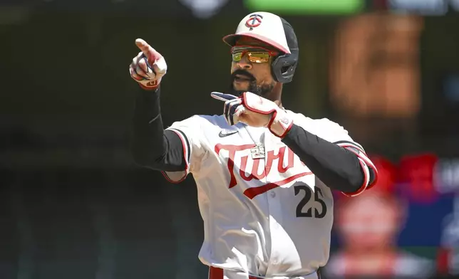 Minnesota Twins's Byron Buxton gestures after hitting a single off Los Angeles Angels pitcher Yusei Kikuchi during the first inning of a baseball game, Saturday, April 26, 2025, in Minneapolis. (AP Photo/Craig Lassig)