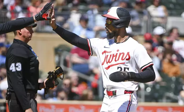 Minnesota Twins' Byron Buxton celebrates after scoring on a Ty France single of Los Angeles Angels pitcher Yusei Kikuchi during the first inning of a baseball game, Saturday, April 26, 2025, in Minneapolis. (AP Photo/Craig Lassig)