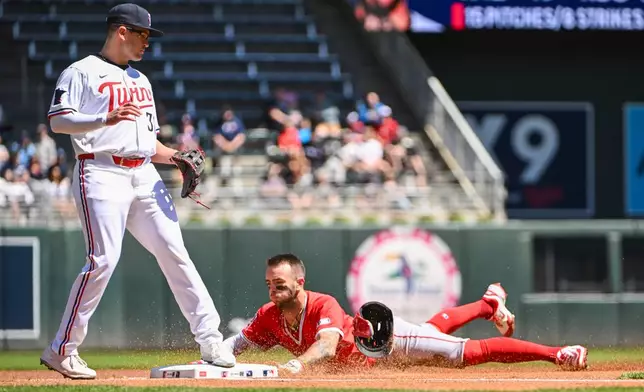 Los Angeles Angels' Zachary Neto steals third base as Minnesota Twins third baseman Jonah Bride looks on during the first inning of a baseball game, Saturday, April 26, 2025, in Minneapolis. (AP Photo/Craig Lassig)