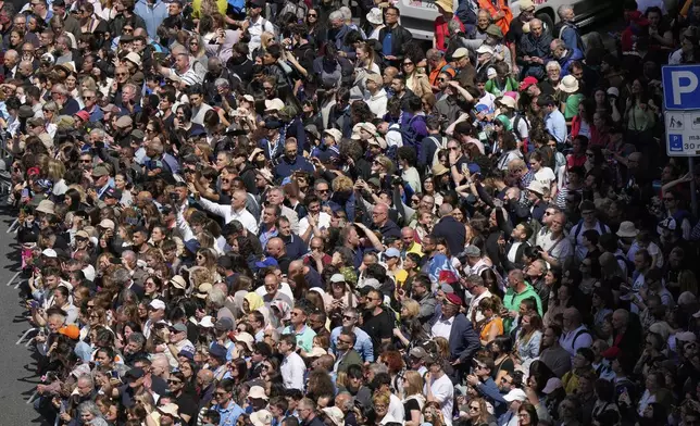 Faithful gather to follow the burial ceremony of Pope Francis at St. Mary Major Basilica in Rome, Saturday, April 26, 2025. (AP Photo/Luca Bruno)
