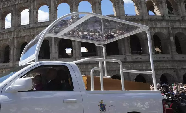 The coffin of Pope Francis is transported in front of the Colosseum on its way to St. Mary Major where he will be buried, Rome, Saturday, April 26, 2025. (AP Photo/Antonio Calanni)