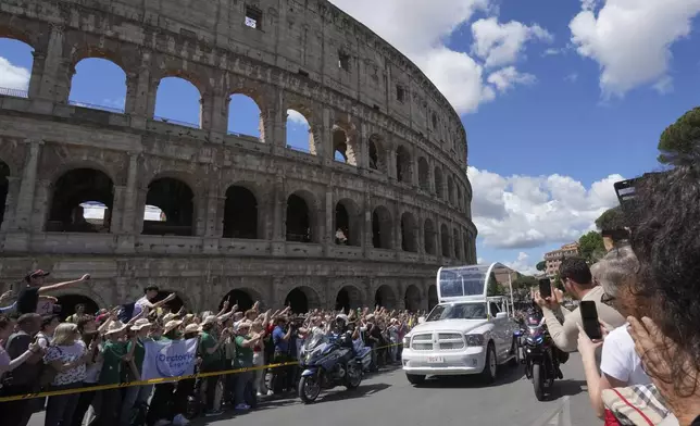 The coffin of Pope Francis is transported in front of the Colosseum on its way to St. Mary Major where he will be buried, Rome, Saturday, April 26, 2025. (AP Photo/Antonio Calanni)