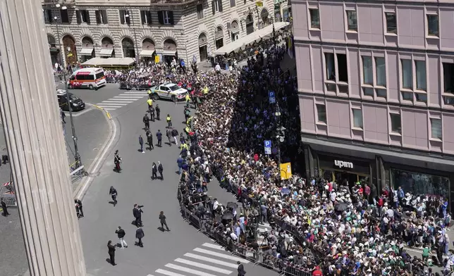 Faithful gather to follow the burial ceremony of Pope Francis at St. Mary Major Basilica in Rome, Saturday, April 26, 2025. (AP Photo/Luca Bruno)