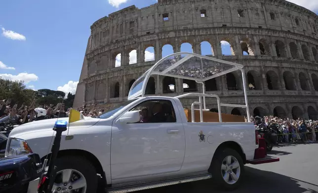 The coffin of Pope Francis is transported in front of the Colosseum on its way to St. Mary Major where he will be buried, Rome, Saturday, April 26, 2025. (AP Photo/Antonio Calanni)
