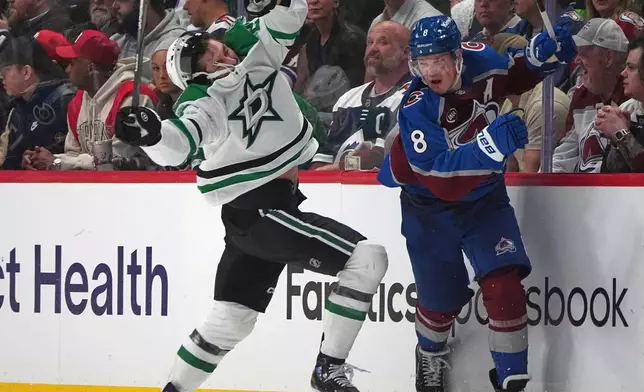 Dallas Stars left wing Mason Marchment, left, reacts after taking a check from Colorado Avalanche defenseman Cale Makar in the second period of Game 3 of an NHL hockey first-round playoff series Wednesday, April 23, 2025, in Denver. (AP Photo/David Zalubowski)