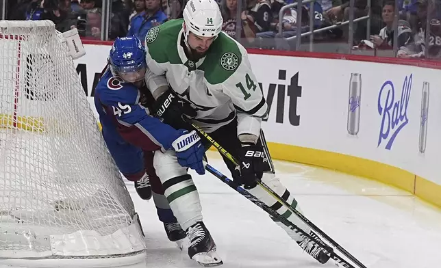 Dallas Stars left wing Jamie Benn, right, tries to wrap around the net as Colorado Avalanche defenseman Samuel Girard covers in the second period of Game 3 of an NHL hockey first-round playoff series Wednesday, April 23, 2025, in Denver. (AP Photo/David Zalubowski)