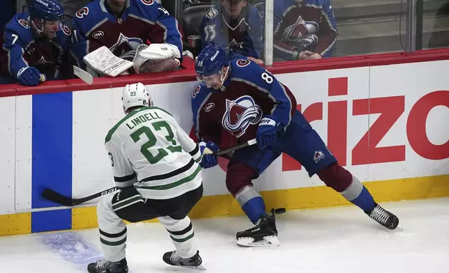 Colorado Avalanche center Martin Necas, right, loses control of the puck as Dallas Stars defenseman Esa Lindell covers in the first period of Game 3 of an NHL hockey first-round playoff series Wednesday, April 23, 2025, in Denver. (AP Photo/David Zalubowski)