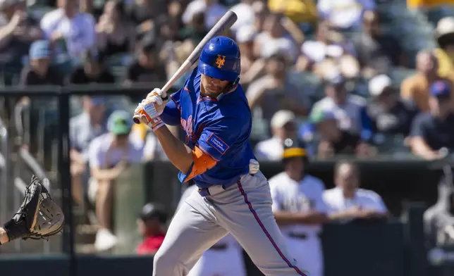 New York Mets' Tyrone Taylor (15) gets hit during the seventh inning of a baseball game against the Athletics Sunday, April 13, 2025, in West Sacramento, Calif. (AP Photo/Sara Nevis)