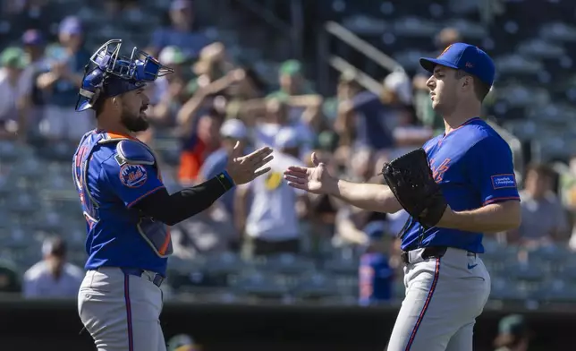 New York Mets catcher Luis Torrens (13) celebrates with Mets pitcher Max Kranick (32) after a baseball game against the Athletics Sunday, April 13, 2025, in West Sacramento, Calif. (AP Photo/Sara Nevis)