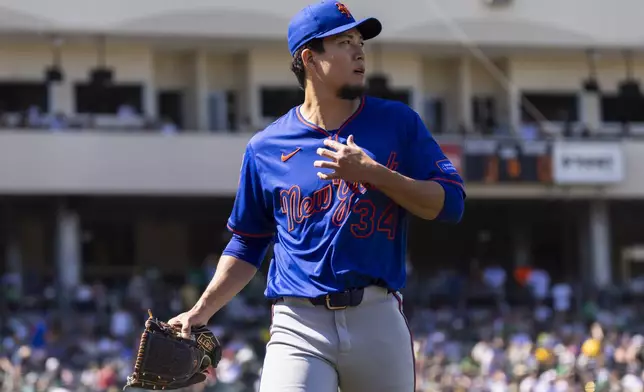 New York Mets pitcher Kodai Senga (34) walks to the dugout during the seventh inning of a baseball game Sunday, April 13, 2025, in West Sacramento, Calif. (AP Photo/Sara Nevis)