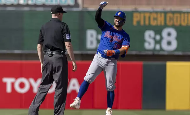 New York Mets' Luis Torrens (13) celebrates after hitting an RBI double during the ninth inning of a baseball game Sunday, April 13, 2025, in West Sacramento, Calif. (AP Photo/Sara Nevis)