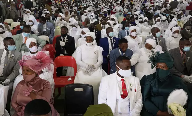 People sit inside a marquee ahead of the mass Easter weddings for 3,000 people, some polygamous, at The International Pentecost Holiness Church in Heidelberg, east of Johannesburg, South Africa, Sunday, April 20, 2025. (AP Photo/Themba Hadebe)