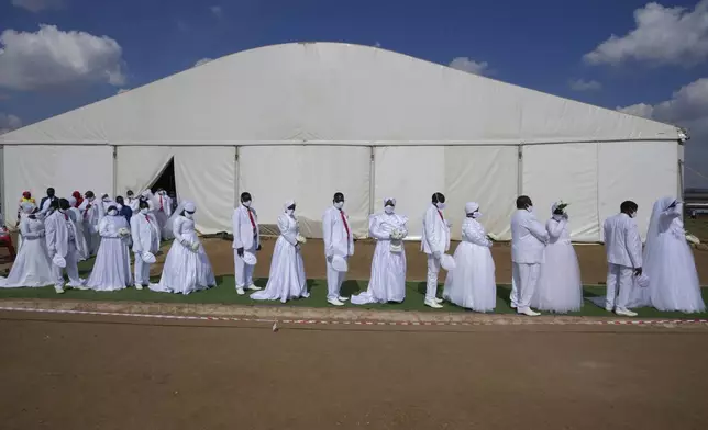 People queue during mass Easter weddings for 3,000 people, some polygamous, at the International Pentecost Holiness Church in Heidelberg, east of Johannesburg, South Africa, Sunday, April 20, 2025. (AP Photo/Themba Hadebe)