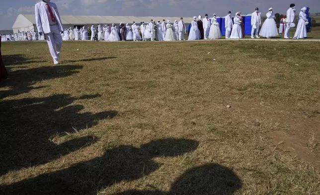 People queue during mass Easter weddings for 3,000 people, some polygamous, at the International Pentecost Holiness Church in Heidelberg, east of Johannesburg, South Africa, Sunday, April 20, 2025. (AP Photo/Themba Hadebe)