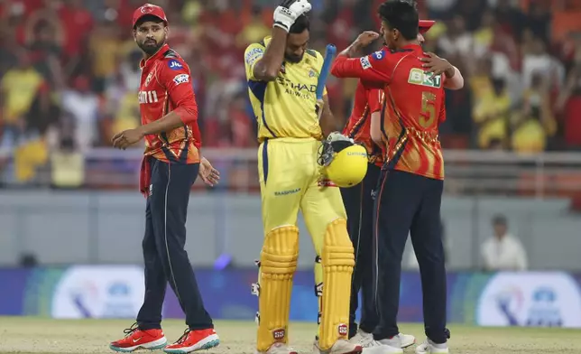 Chennai Super Kings' Vijay Shankar, center, reacts as players of Punjab Kings celebrate after their win in the Indian Premier League cricket match between Punjab Kings and Chennai Super Kings at Maharaja Yadavindra Singh Cricket Stadium in Mohali, India, Tuesday, April 8, 2025. (AP Photo/Surjeet Yadav)