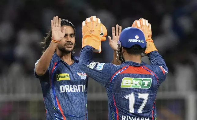 Lucknow Super Giants' Digvesh Rathi, left, and Lucknow Super Giants' captain Rishabh Pant celebrates the dismissal of Kolkata Knight Riders' Sunil Narine during the Indian Premier League cricket match between Kolkata Knight Riders and Lucknow Super Giants at Eden Gardens in Kolkata, India, Tuesday, April 8, 2025. (AP Photo/Bikas Das)