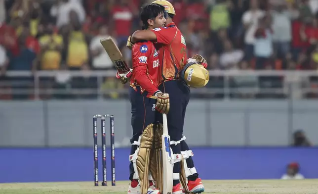 Punjab Kings' Priyansh Arya, left, celebrates with batting partner Shashank Singh after scoring a century during the Indian Premier League cricket match between Punjab Kings and Chennai Super Kings at Maharaja Yadavindra Singh Cricket Stadium in Mohali, India, Tuesday, April 8, 2025. (AP Photo/Surjeet Yadav)