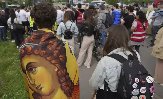 People stand in silence to commemorate the a deadly train station canopy collapse during a farewell ceremony by Serbia's protesting students in Novi Sad, Serbia, Friday, April 25, 2025. (AP Photo/Darko Vojinovic)