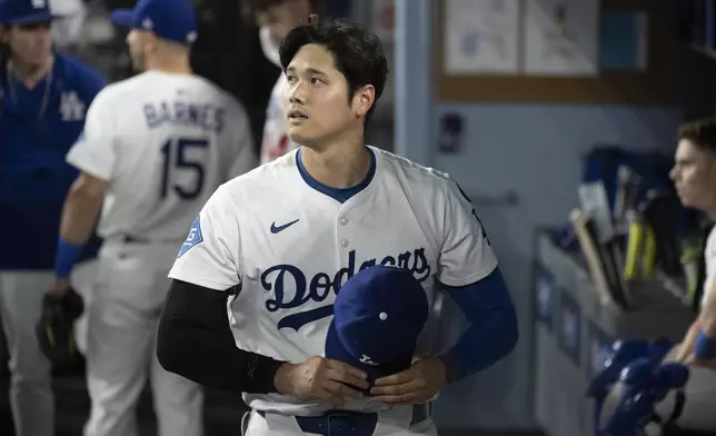Los Angeles Dodgers' Shohei Ohtani walks back to the clubhouse during the seventh inning of a baseball game against the Miami Marlins in Los Angeles, Tuesday, April 29, 2025. (AP Photo/Kyusung Gong)