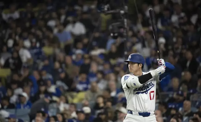Los Angeles Dodgers' Shohei Ohtani stands in the on-deck circle during the sixth inning of a baseball game against the Miami Marlins in Los Angeles, Tuesday, April 29, 2025. (AP Photo/Kyusung Gong)