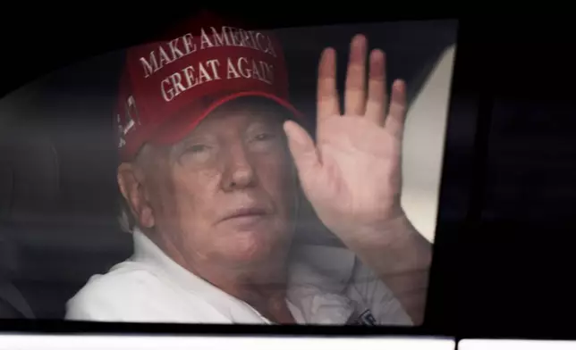 President Donald Trump waves to supporters from his limousine as he arrives at Trump International Golf Club, Saturday, March 29, 2025, in West Palm Beach, Fla. (AP Photo/Manuel Balce Ceneta)