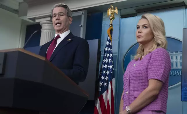 Treasury Secretary Scott Bessent with White House press secretary Karoline Leavitt, right, speaks to reporters in the James Brady Press Briefing Room at the White House, Tuesday, April 29, 2025, in Washington. (AP Photo/Manuel Balce Ceneta)