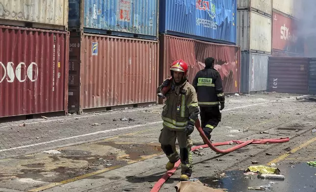 In this photo provided by the Iranian Red Crescent Society on Sunday, April 27, 2025, firefighters work after a massive explosion and fire rocked the Shahid Rajaei port near the southern port city of Bandar Abbas, Iran, on Saturday. (Iranian Red Crescent Society via AP)