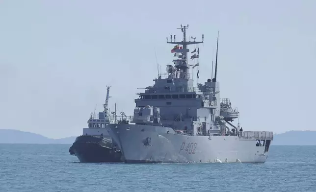 An Italian navy ship approaches the port, as Italian authorities transfer 40 migrants with no permission to remain in the country to Italian-run migration detention centers in Albania, in Shengjin, northwestern Albania, Friday, April 11, 2025. (AP Photo/Vlasov Sulaj)