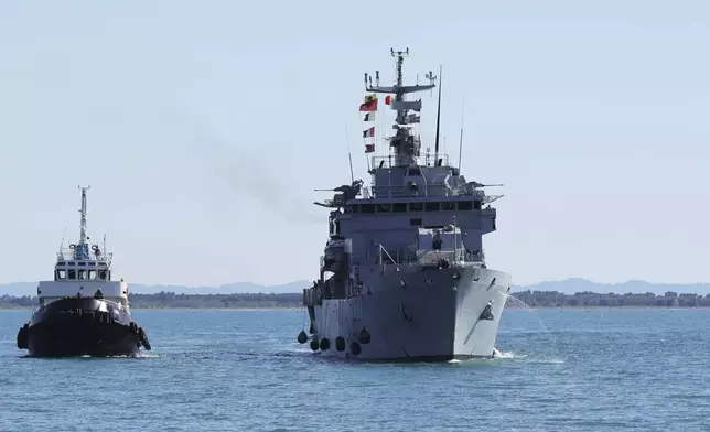 An Italian navy ship approaches the port , as Italian authorities transfer 40 migrants with no permission to remain in the country to Italian-run migration detention centers in Albania, in Shengjin, northwestern Albania, Friday, April 11, 2025. (AP Photo/Vlasov Sulaj)