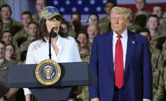 President Donald Trump listens as Michigan Gov. Gretchen Whitmer speaks to members of the Michigan National Guard at Selfridge Air National Guard Base, Tuesday, April 29, 2025, in Harrison Township, Mich. (AP Photo/Alex Brandon)