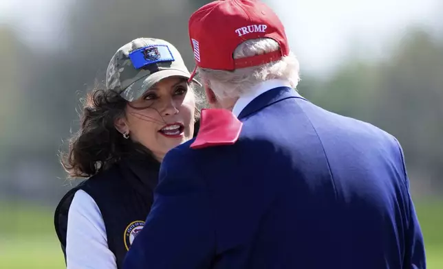 Michigan Gov. Gretchen Whitmer greets President Donald Trump as he arrives on Air Force One at Selfridge Air National Guard Base, Tuesday, April 29, 2025, in Harrison Township, Mich. (AP Photo/Alex Brandon)